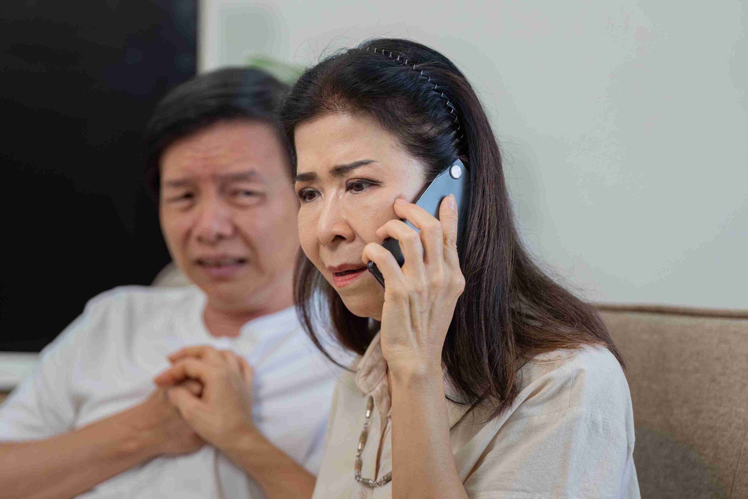Worried woman speaking with her doctor over the mobile phone.