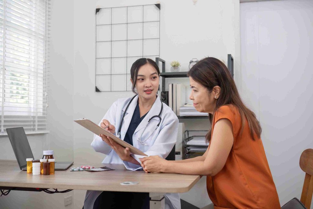 Young doctor speaking with an elderly patient.
