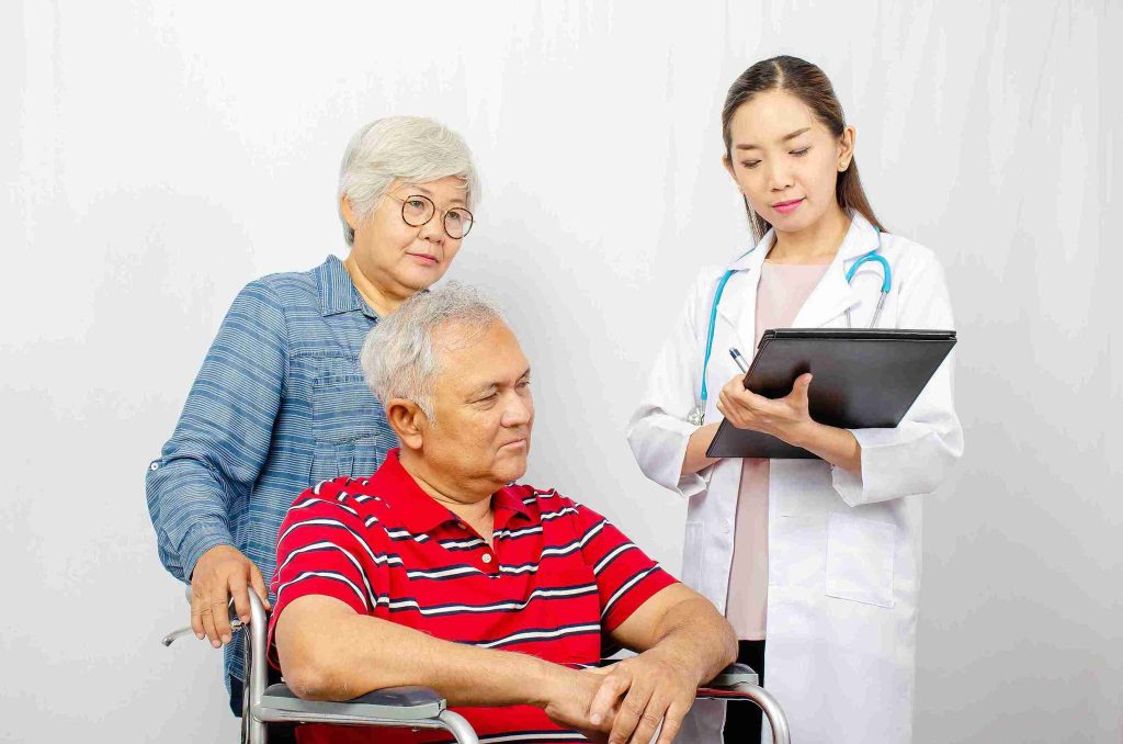 Elderly couple speaking with their doctor.