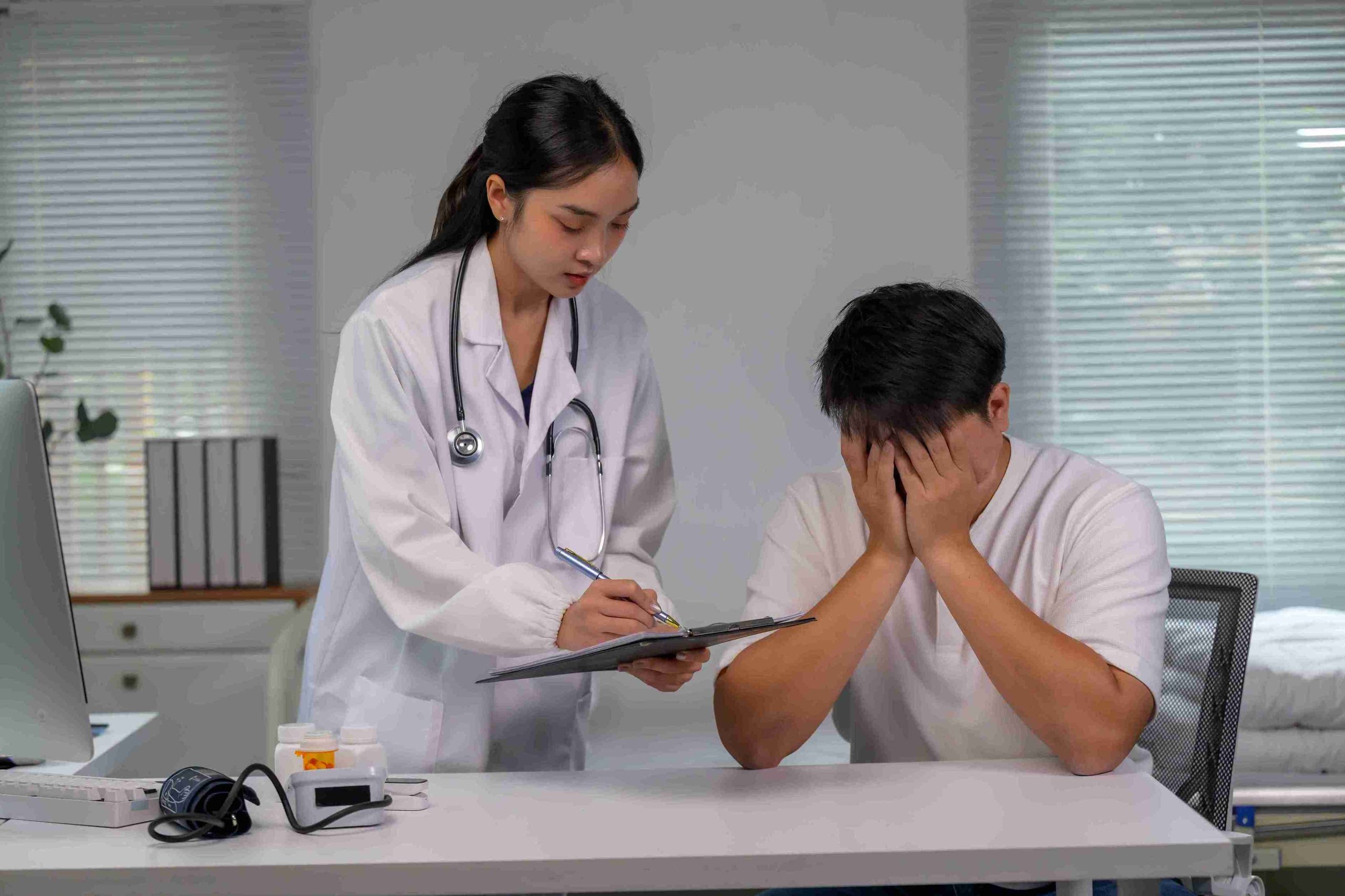Doctor consoling a very worried patient after cancer diagnosis.