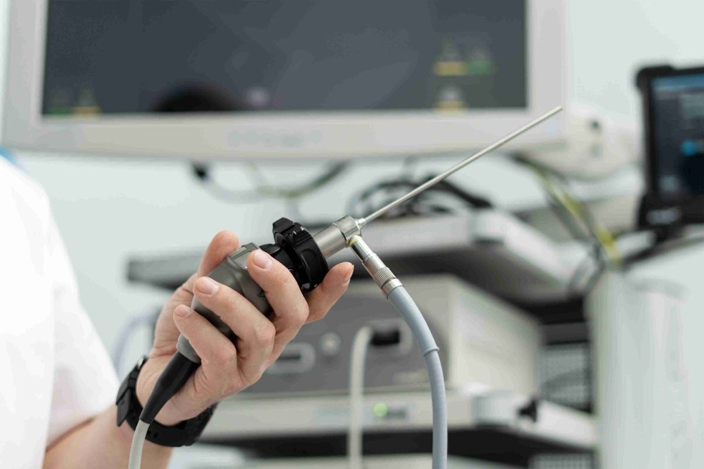Healthcare worker holding a medical endoscope.