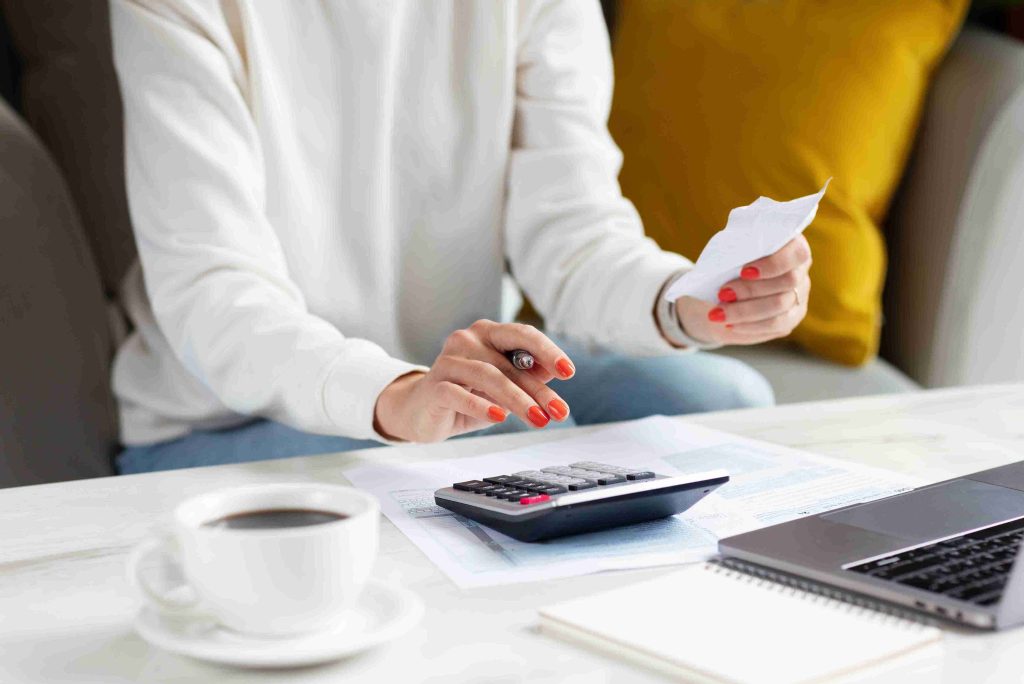 Woman calculating the cost of a medical procedure.