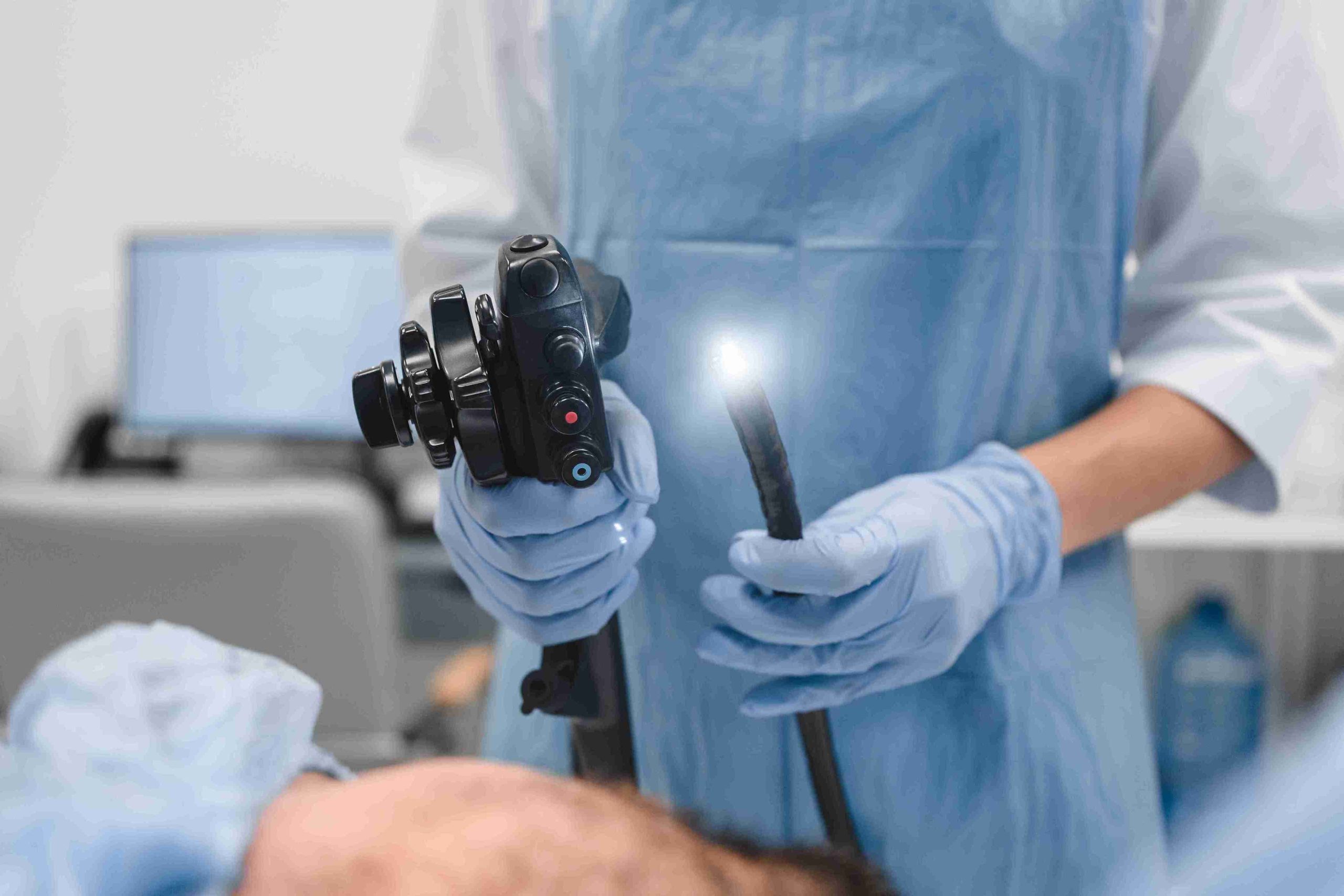 Doctor holding an endoscope for gastroscopy.