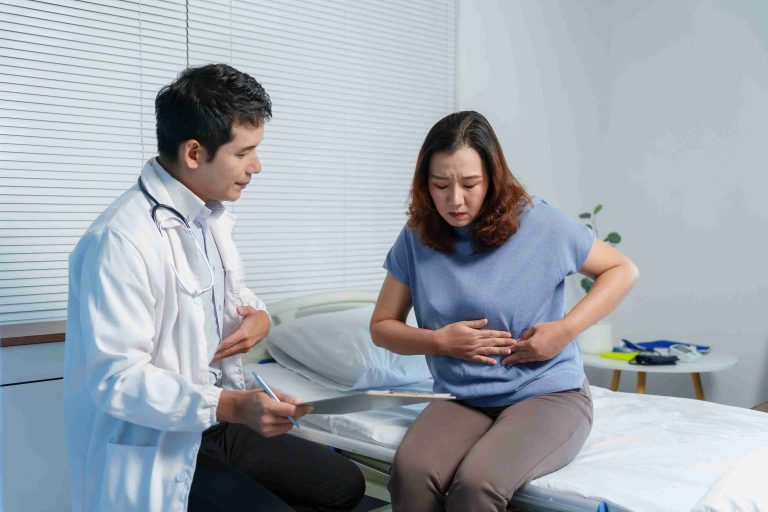 Doctor examining a patient with abdominal pain.