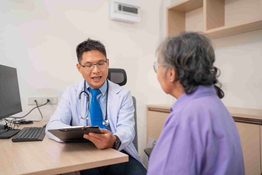 Doctor explaining a procedure to an elderly patient.