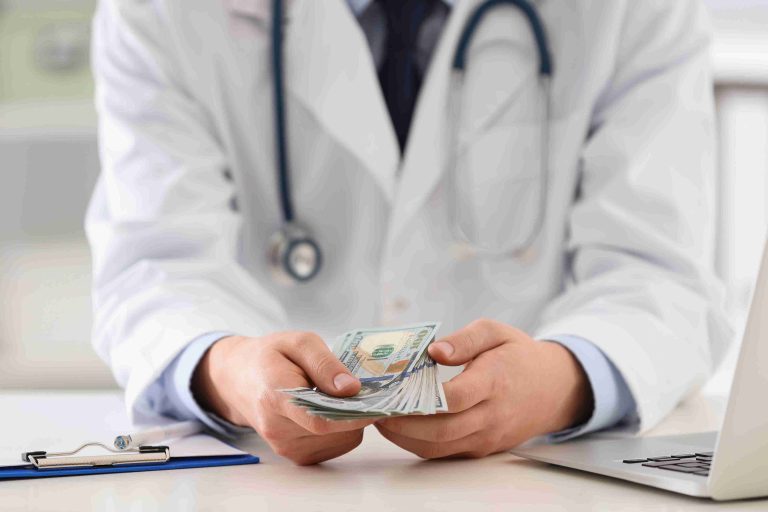 Doctor counting money paid by the patient.
