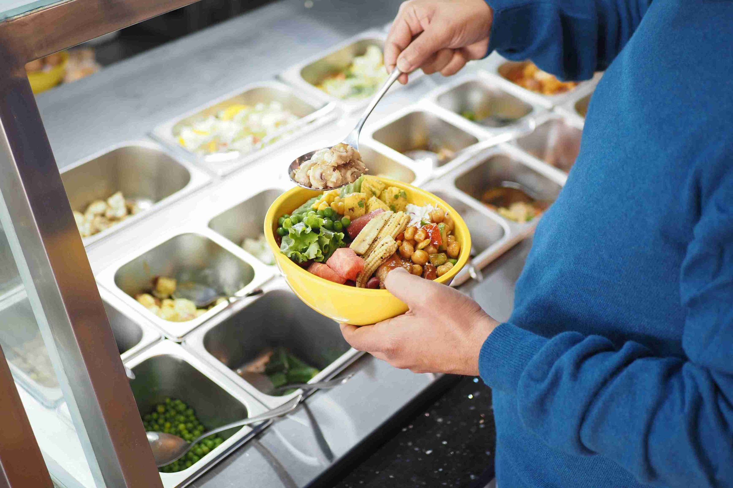 Person enjoying a bowl of healthy salad.