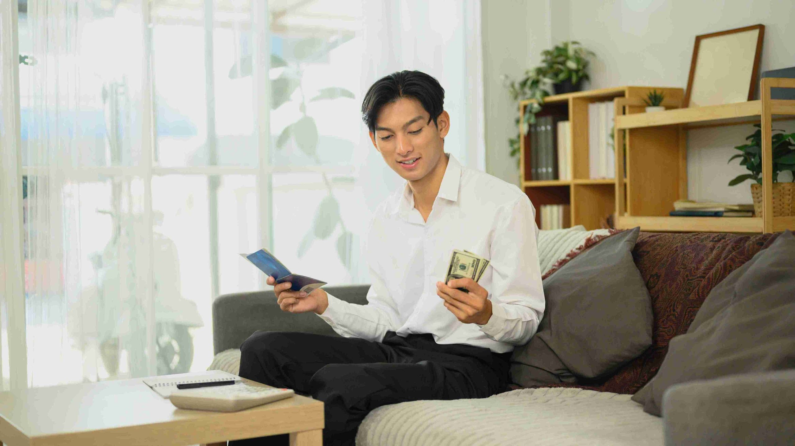 Young man counting money he saved from medical procedures.