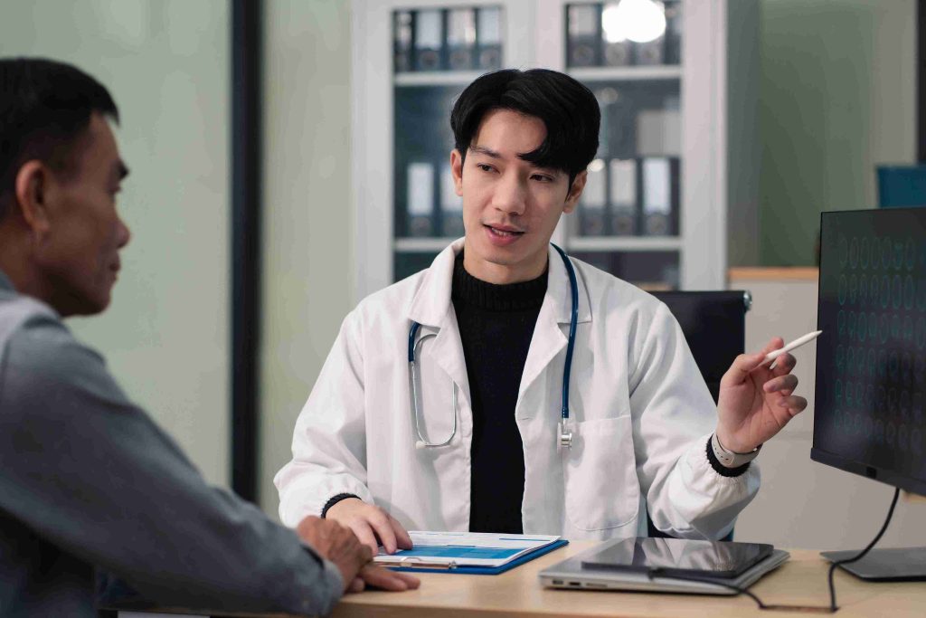 Young doctor speaking with an elderly patient.