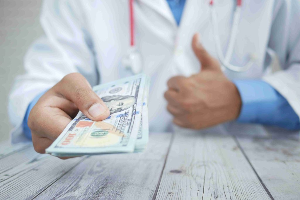 Doctor receiving payment from a patient.