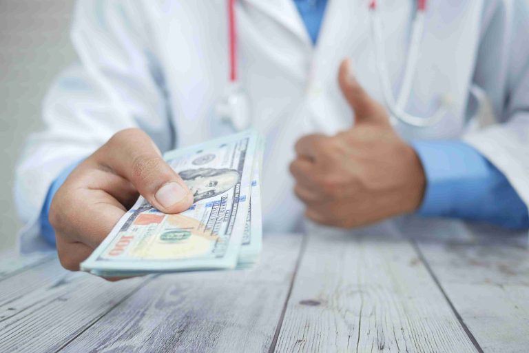 Doctor receiving payment from a patient.