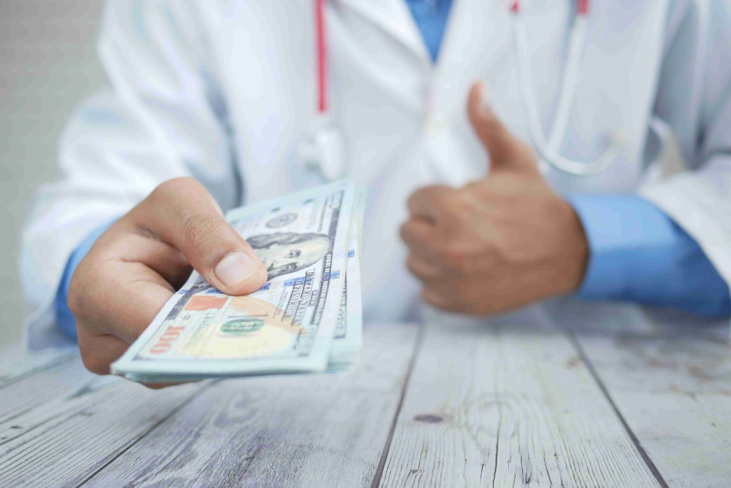 Doctor receiving payment from a patient.