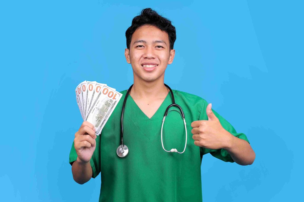 Healthcare professional holding a stack of cash.