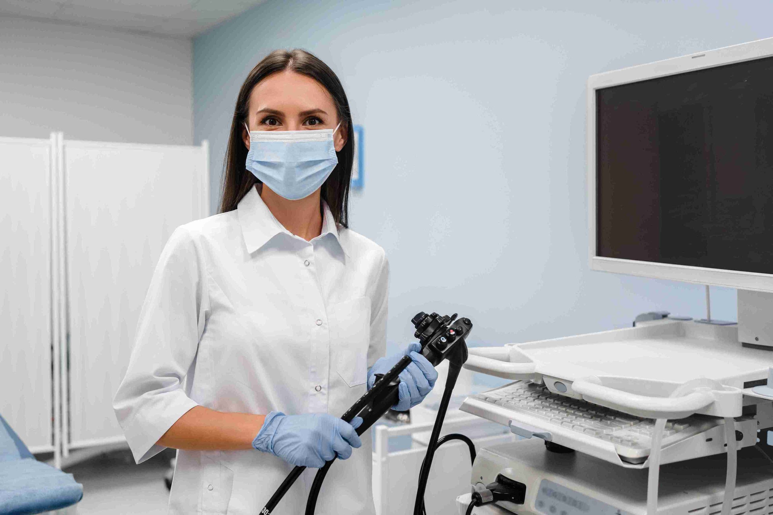 Healthcare worker holding an endoscope.