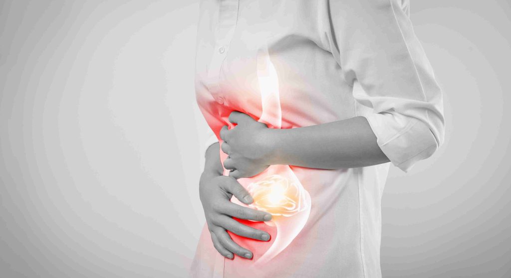 Image of a woman with her hand on her stomach.