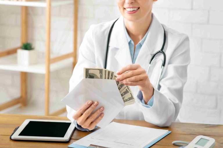 Doctor counting dollar bills in a white envelope.