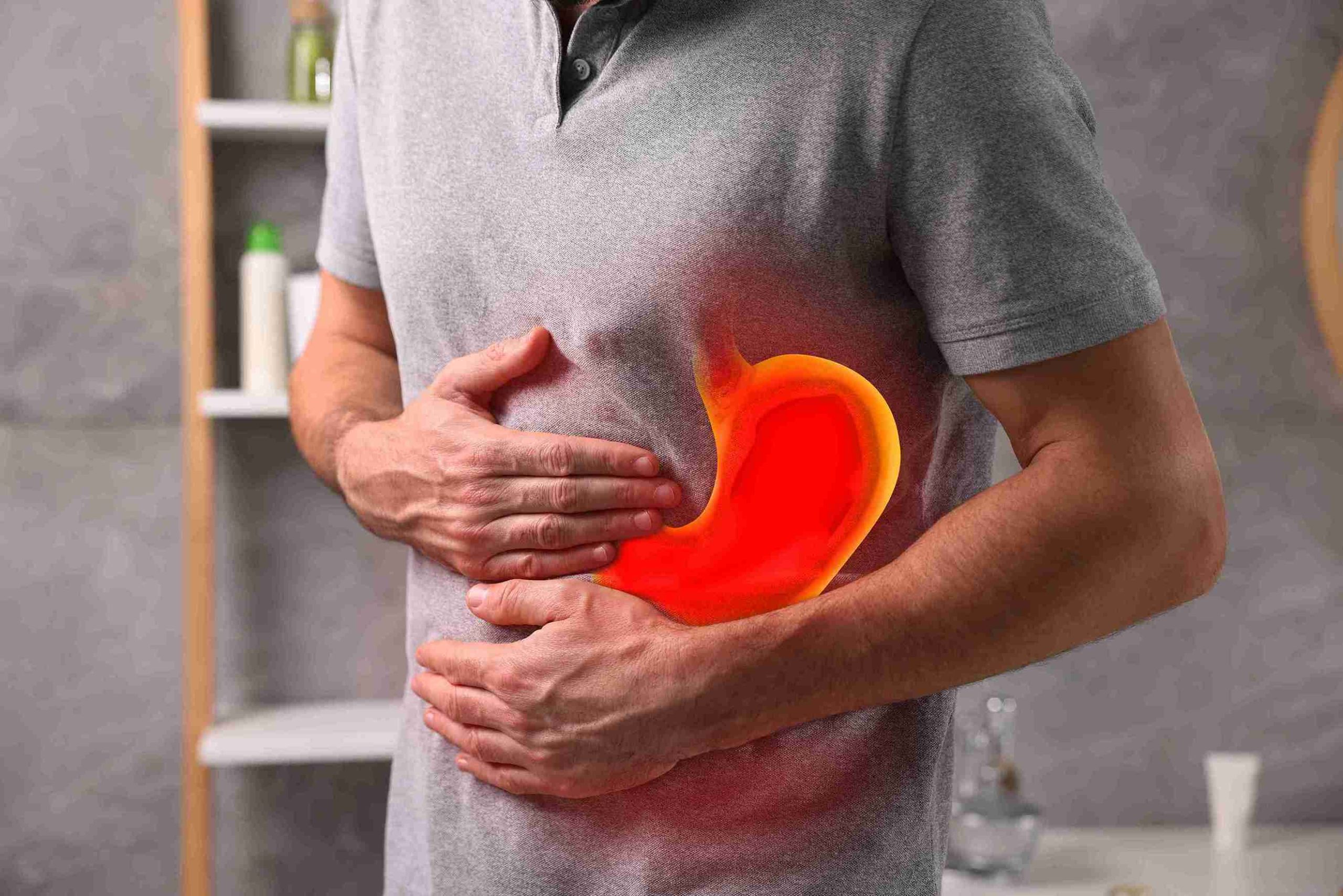 Man with stomach pain, with both hands on his stomach.