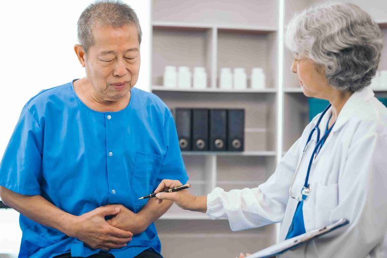 Gastroenterologist explaining what is normal after a colonoscopy? recovery symptoms and warning signs using a 3D colon model.