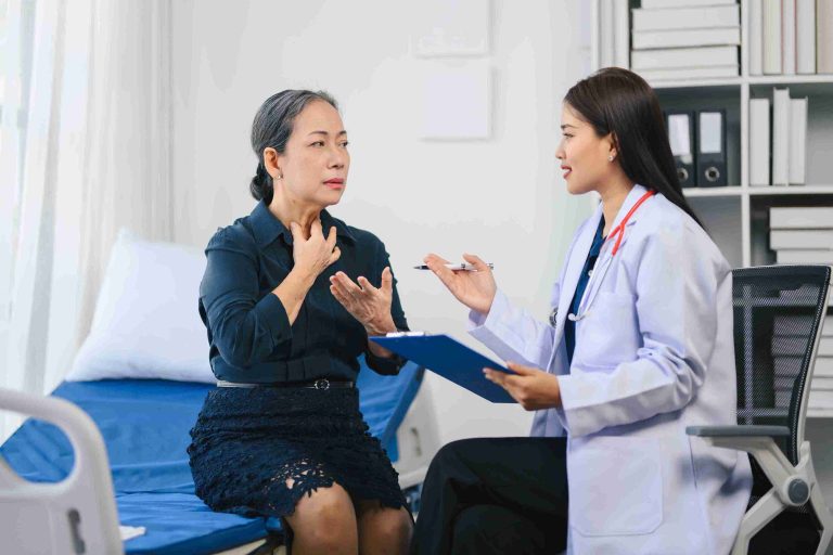 Elderly patient speaking with a doctor.