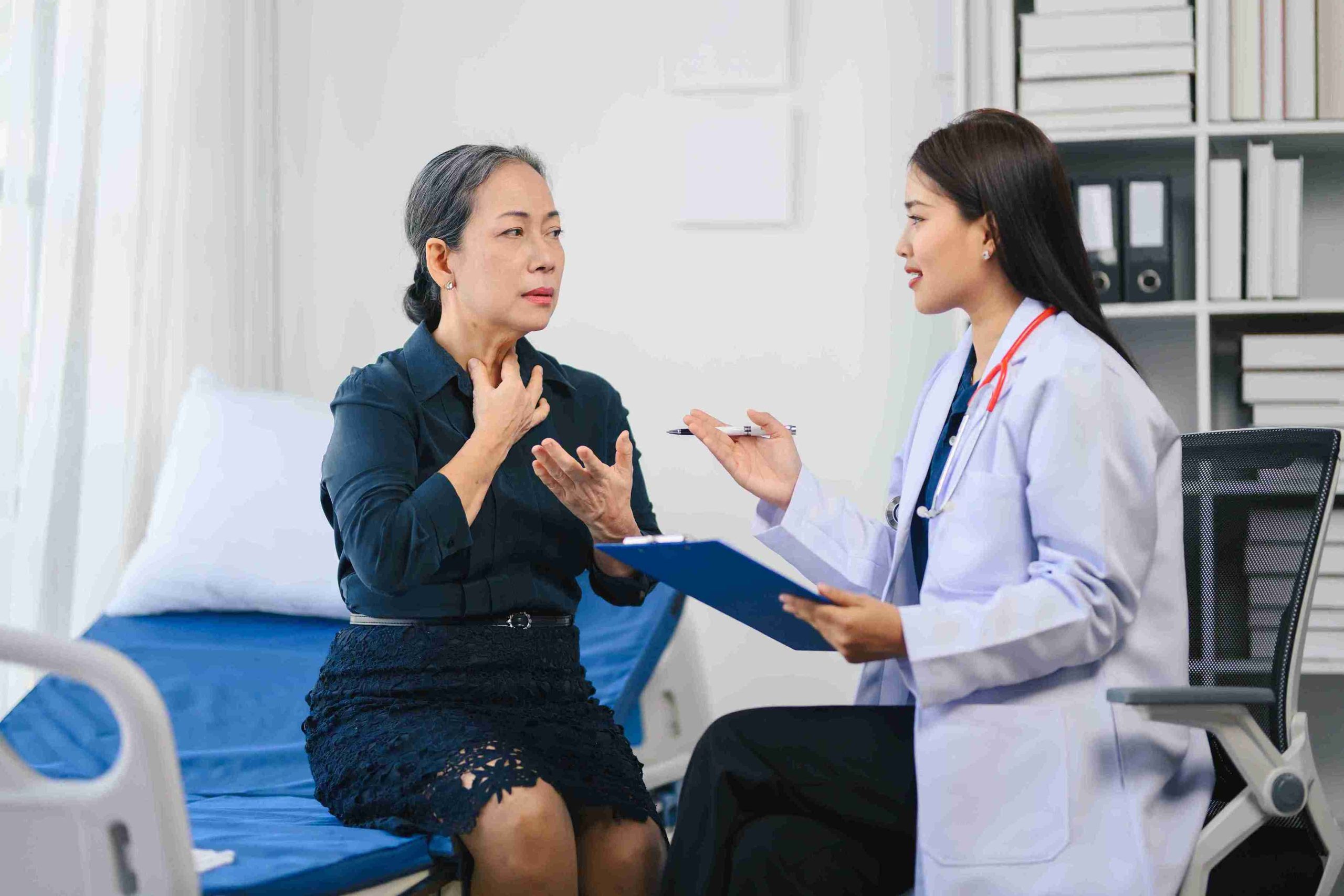 Elderly patient speaking with a doctor.