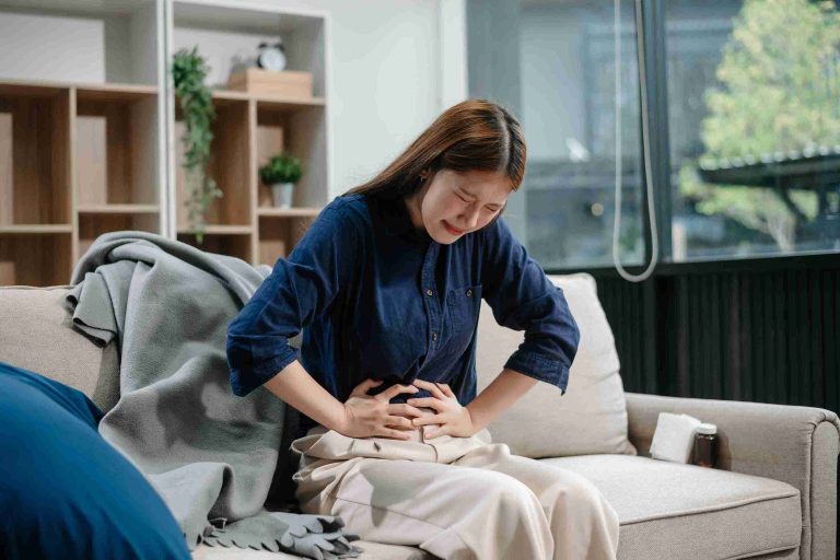 Doctor discussing diagnosis and early detection of is it ordinary abdominal pain or appendicitis? signs to watch out for with a patient.